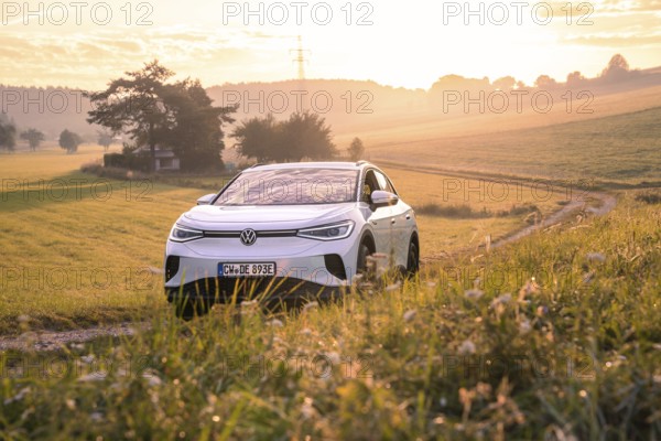 Car at sunset in peaceful countryside, VW ID4 electric car, Deer Carsharing, Calw, Germany