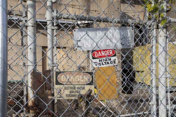 Washington, DC - Signs on a locked gate warn of high voltage and electrical hazards at a Pepco electrical substation at Buzzard Point
