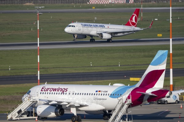 Turkish Airlines Airbus A320-200 landing at Düsseldorf airport, Eurowings Airbus on outdoor position, DUS