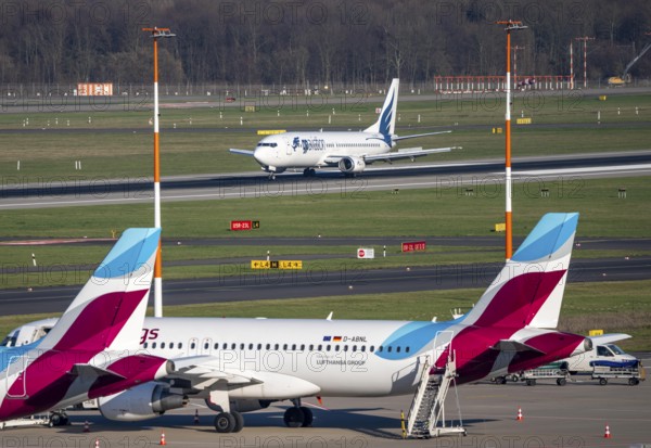 Boeing 737-400 of Bulgarian airline GP Aviation Limited landing, Eurowings aircraft parked in outdoor positions, Düsseldorf airport, DUS