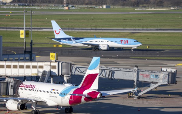 Eurowings aircraft, at Terminal A and TUI Fly Boeing 737 on the way to takeoff, Düsseldorf airport, DUS