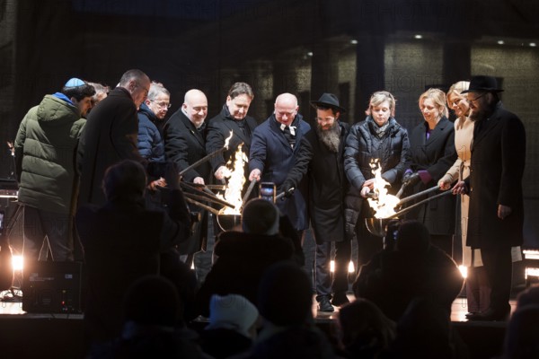 Karsten Dreinhöfer (Chairman of the Margot Friedländer Foundation), Kai Wegner (Governing Mayor of Berlin), Julia Klöckner (President of the German Bundestag) and Yehuda Teichtal (Rabbi of the Chabad-Lubavitch movement) light the fire together with other participants at the lighting of the 20th anniversary Hanukkah in front of the Brandenburg Gate, Berlin, 17 December 2025