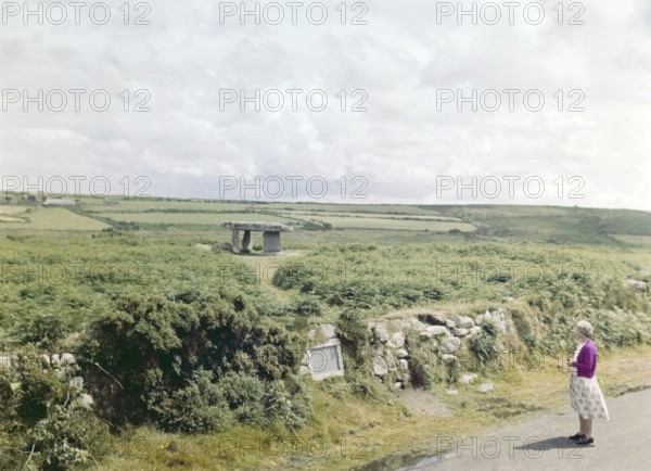 Woman visiting Lanyon Quoit, prehistoric Neolithic chambered tomb, Cornwall, England, UK, c 1960