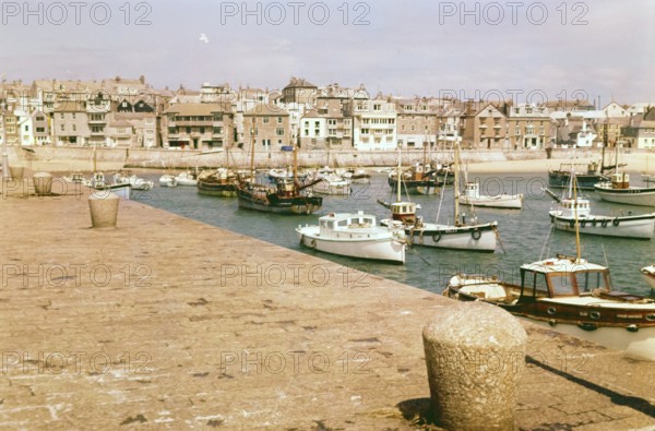 Boats at moorings in the harbour at St Ives, Cornwall, England, UK c 1960