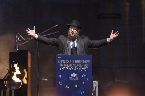Yehuda Teichtal (Rabbi of the Chabad-Lubavitch movement) speaks at the lighting of lights to mark 20 years of Hanukkah in front of the Brandenburg Tor tor, Berlin, 17 December 2025