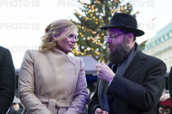 Julia Klöckner (President of the German Bundestag) and Yehuda Teichtal (Rabbi of the Chabad-Lubavitch movement) at the lighting of lights to mark 20 years of Hanukkah in front of the Brandenburg Tor, Berlin, 17 December 2025