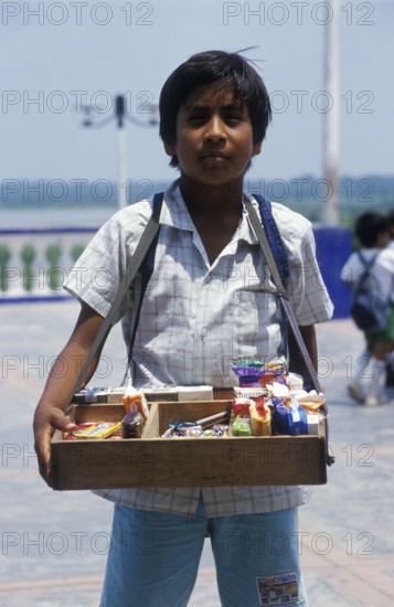 Boy with belly shop selling sweets in Iquitos, Amazon basin, Peru, South America, September 1997, vintage, retro, old, historic
