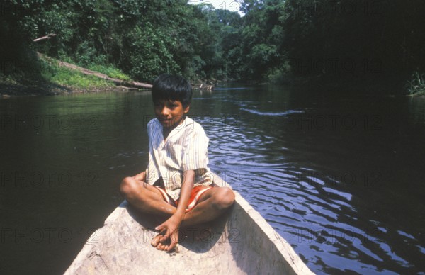 Little boy in a canoe, Rio Yanayacu, Amazon region near Iquitos, Peru, South America, September 1997, vintage, retro, old, historic