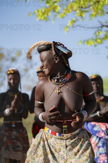 Traditional dance, brightly decorated woman of the Hakaona tribe also dance Havakona or Hakawona, near Opuwo, Kunene, Namibia