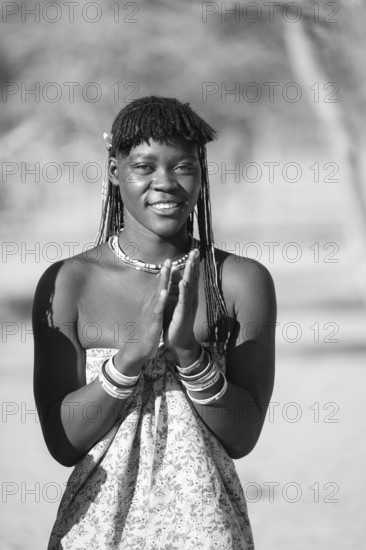 Black and white, traditional dance, brightly decorated woman of the Hakaona tribe dance, also Havakona or Hakawona, near Opuwo, Kunene, Namibia