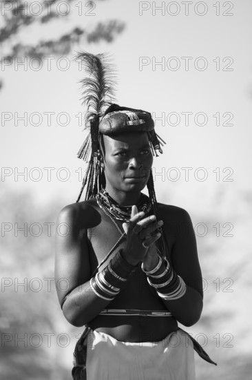 Black and white, traditional dance, brightly decorated woman of the Hakaona tribe also Havakona or Hakawona, near Opuwo, Kunene, Namibia