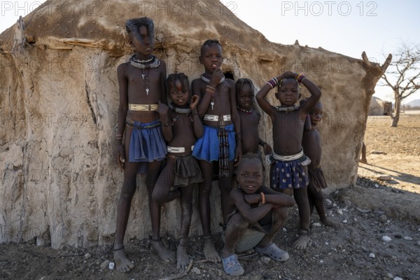 Himba children standing in the shade of a hut, traditional Himba village, Kaokoveld, Kunene, Namibia