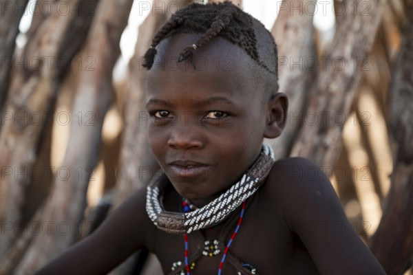 Portrait, cheerful Himba child, traditional Himba village, Kaokoveld, Kunene, Namibia