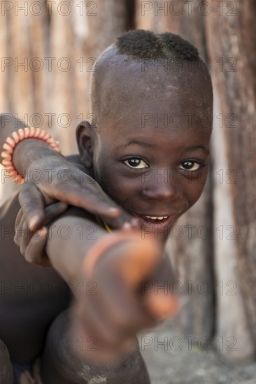 Portrait, funny Himba child, traditional Himba village, Kaokoveld, Kunene, Namibia
