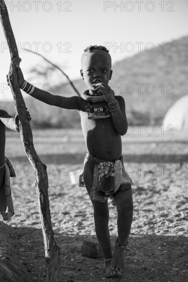 Black and white, young Himba child, traditional Himba village, Kaokoveld, Kunene, Namibia