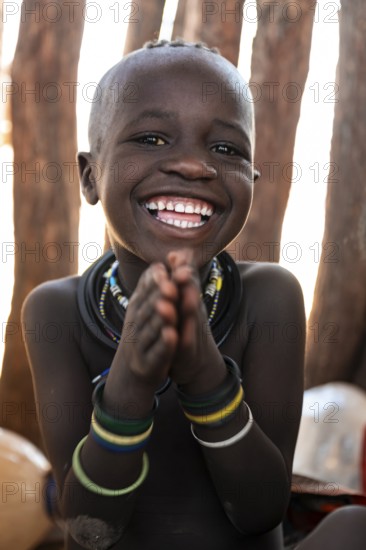 Portrait, laughing Himba child, traditional Himba village, Kaokoveld, Kunene, Namibia
