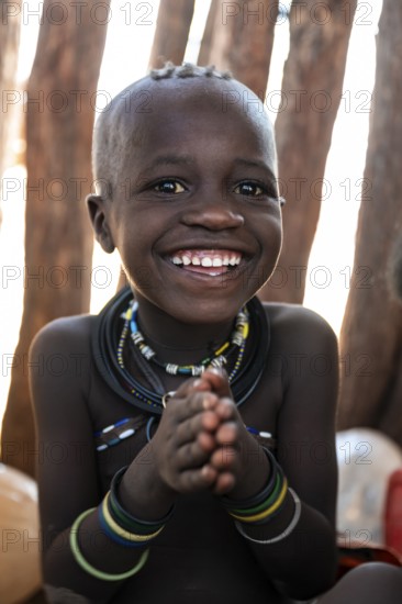 Portrait, grinning Himba child, traditional Himba village, Kaokoveld, Kunene, Namibia