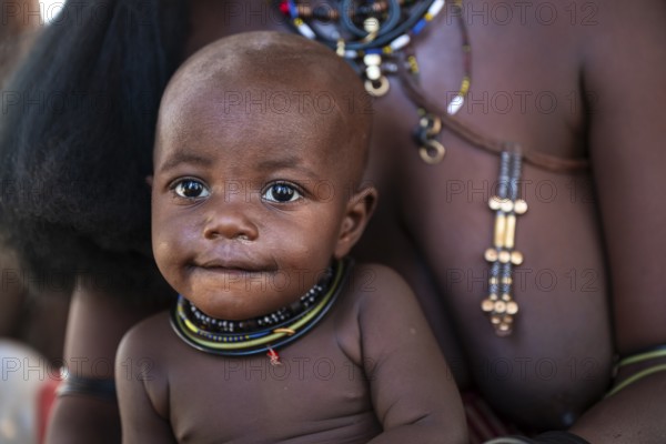 Himba woman with baby, portrait, traditional Himba village, Kaokoveld, Kunene, Namibia