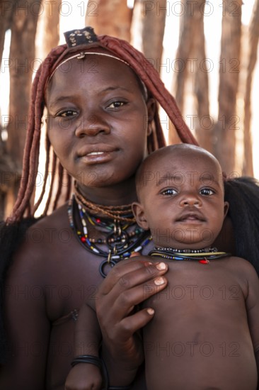Himba woman with baby, traditional Himba village, Kaokoveld, Kunene, Namibia