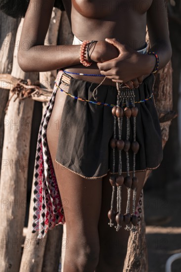 Detail, jewelry and clothing, young Himba woman, traditional Himba village, Kaokoveld, Kunene, Namibia