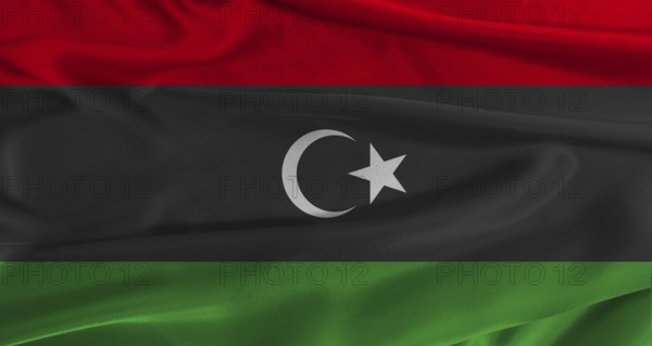 Flag of Libya with fabric textured background. Close up of National flag of Libya with realistic texture