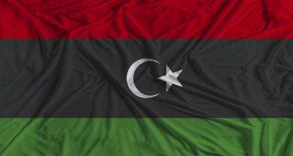 Libya flag with fabric texture background. National flag of Libya with cloth texture