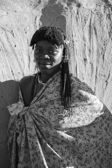 Black and white, portrait, brightly decorated woman of the Hakaona tribe, also Havakona or Hakawona, near Opuwo, Kunene, Namibia