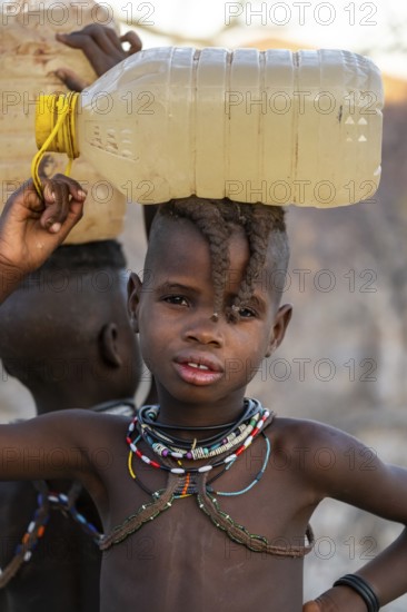 Himba child fetches water, carries water bottle, traditional Himba, Kaokoveld, Kunene, Namibia
