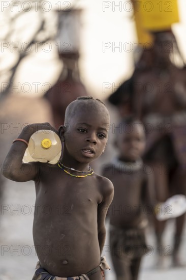 Himba children fetches water, carries water bottle, traditional Himba, Kaokoveld, Kunene, Namibia