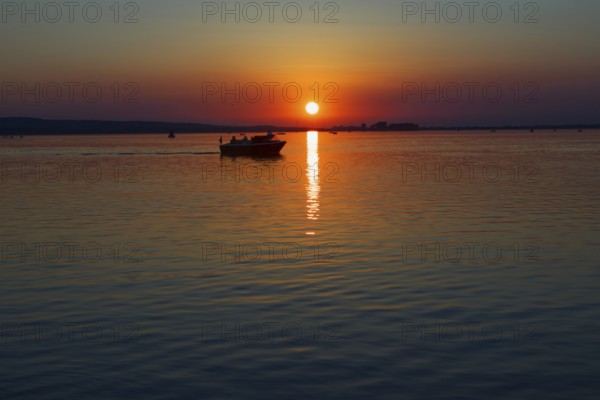 Sunset over the Steinhuder Meer with boat at dusk, quiet scene, Steinhude