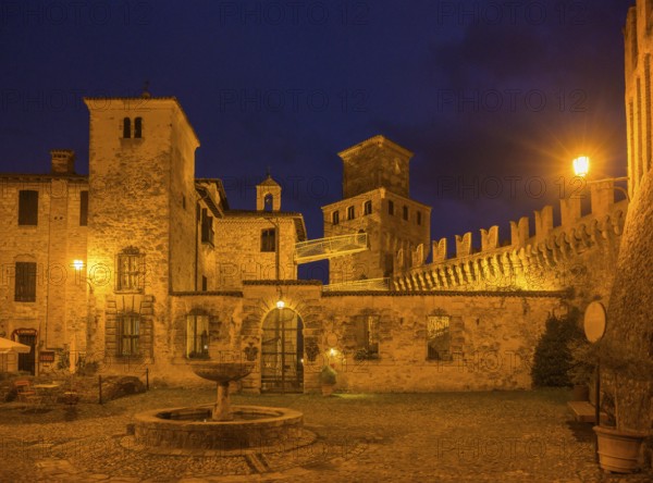The castle and defensive walls illuminated, Borgo di Vigoleno, Vernasca, Province of Piacenza, Italy