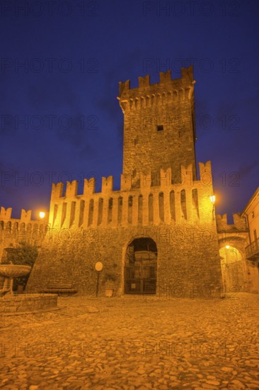 The castle and defensive walls illuminated, Borgo di Vigoleno, Vernasca, Province of Piacenza, Italy