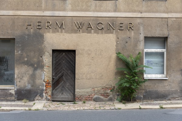 Dilapidated building with the inscription Herm Wagner, Altenburg, Thuringia, Germany