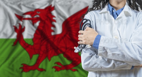 Healthcare professional with Wales flag background. Professional doctor holding stethoscope on Wales flag background