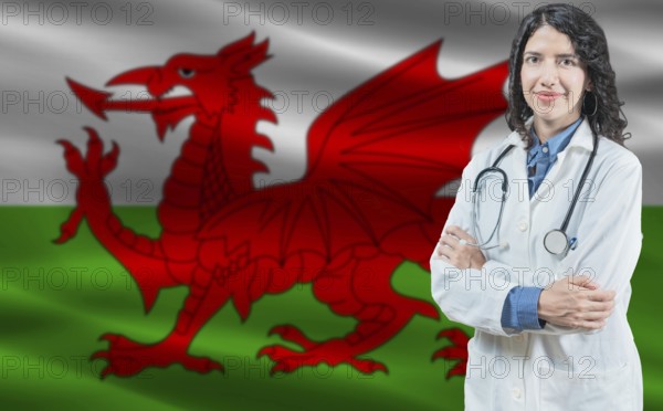 Welsh medicine and healthcare concept. Doctor close up against Wales flag background