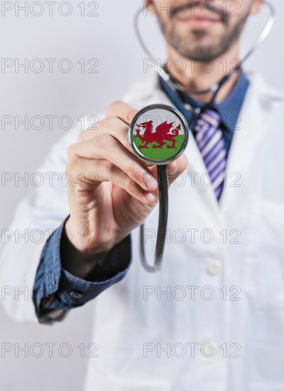 Wales health and medical insurance concept. Wales healthcare system, doctor holding stethoscope