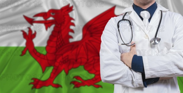 Male doctor with stethoscope on Wales flag. Doctor holding stethoscope on Wales flag