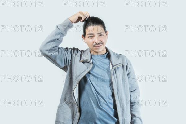 Confused guy scratching head isolated. Worried man scratching head with confused face isolated