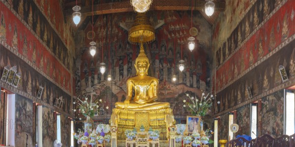 Golden Buddha statue with Bhumispara-mudra, Buddha Gautama at the moment of enlightenment, ordination or main room with elaborate murals (Ayutthaya- Thonburi style), Wat Suwannaram Ratchaworawihan (often shortened to Wat Suwannaram or Wat Suwan), on the west side of the Chao Phraya (Khlong Bangkok Noi) in Bangkok-Noi, Bangkok, Thailand