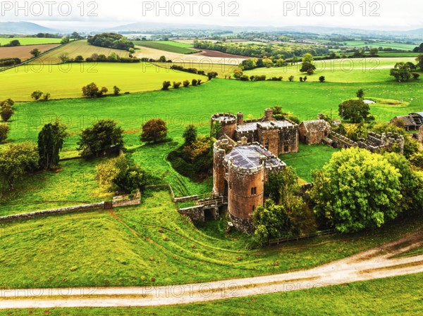 Autumn Colours over ruins of Pembridge Castle or Newland Castle from a drone, Herefordshire, England, United Kingdom