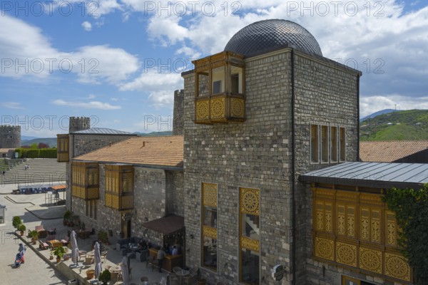 Buildings with stone walls, decorative wooden elements and domed roof under a blue sky, Rabati Fortress, Akhaltsikhe, Samtskhe-Javakheti region, Samtskhe-Javakheti, Georgia