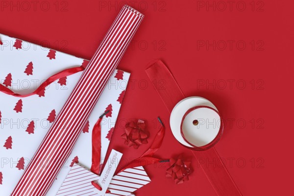 Top view of red and white Christmas wrapping material like bags, paper and ribbons
