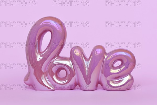 Cute Valentine's day text ornament 'love' on pastel pink background