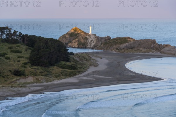 Deliverance Cove and Castlepoint Lighthouse on the rock, ocean, evening. Castlepoint, Wairarapa Coast, Wellington Region, North Island, New Zealand