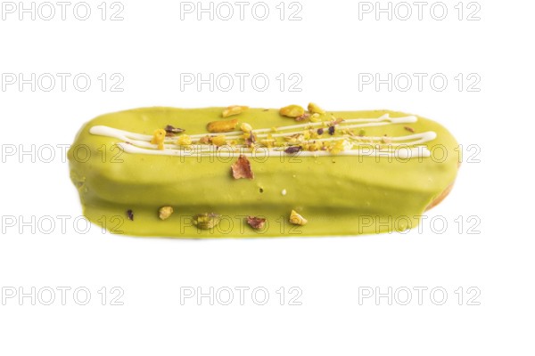 Glazed green Eclair on brown concrete isolated on white, side view, close up