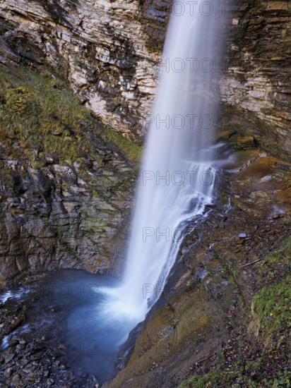 Diesbach waterfall in autumn-colored surroundings, Linthal, Klausenpass, Canton of Glarus, Switzerland