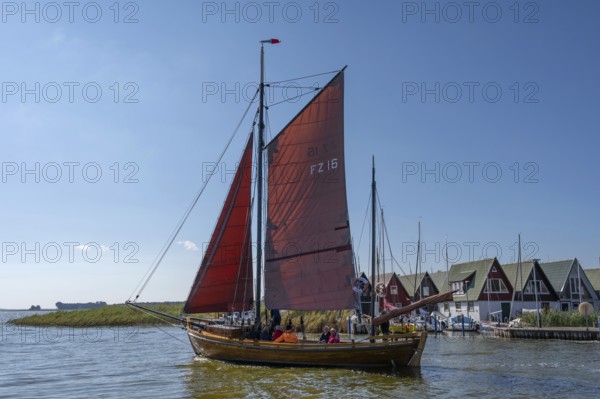 Zeesboot, former historic fishing boat, leaves the port of Ahrenshoop, blue sky, Darß, Mecklenburg-Western Pomerania, Germany