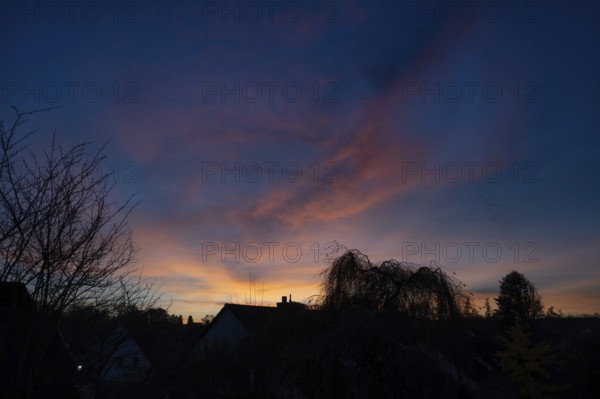 Evening sky with house and tree silhouettes, Eckental, Middle Franconia, Bavaria, Germany