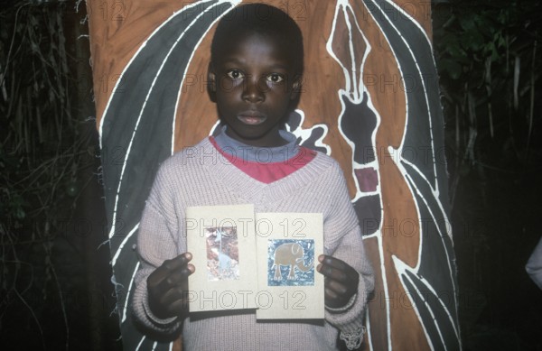 Child with homemade artwork in a self-help project in Chitungwiza near Harare, Zimbabwe, Africa, June 2000, vintage, retro, old, historical
