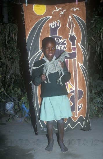 Child with homemade artwork in a self-help project in Chitungwiza near Harare, Zimbabwe, Africa, June 2000, vintage, retro, old, historical